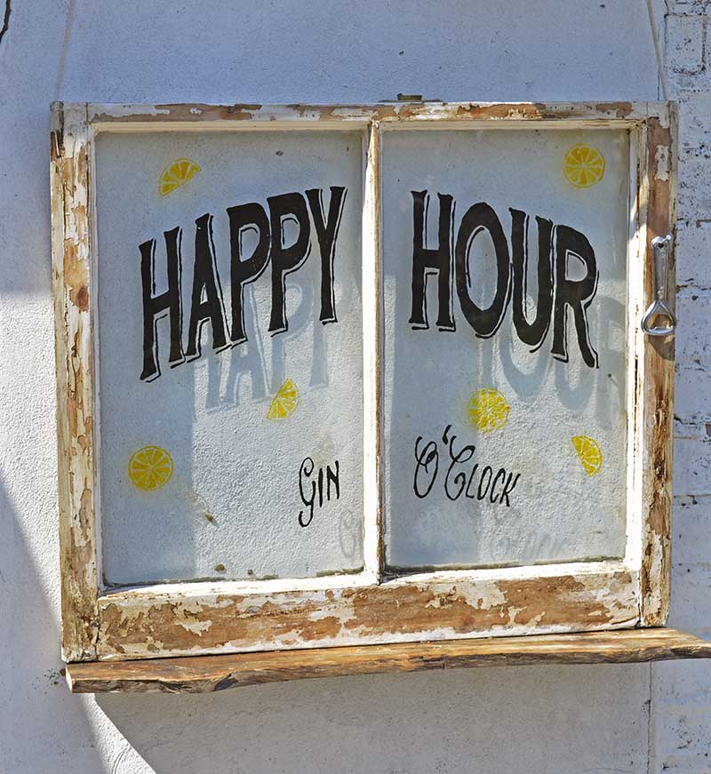 Glass window painted with Happy Hour sign