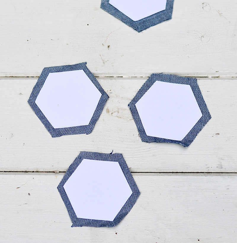 paper hexagon on denim cutouts for patchwork