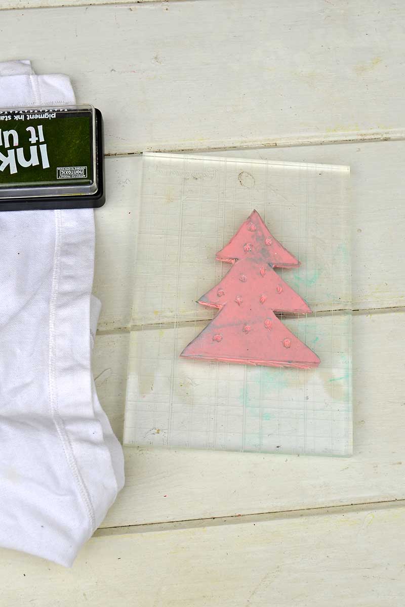 sicking carved Christmas tree stamp to block