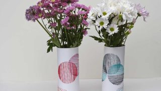 pair of hand embroidered paper sleeve vases with flowers