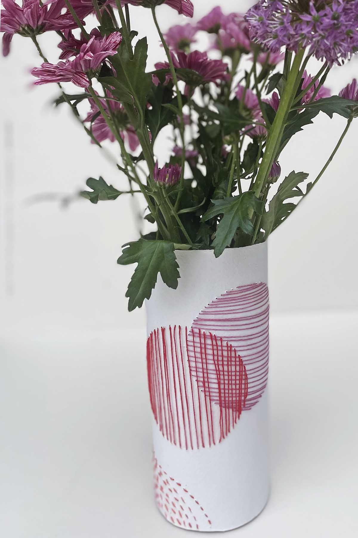 Pink embroidered paper vase close up