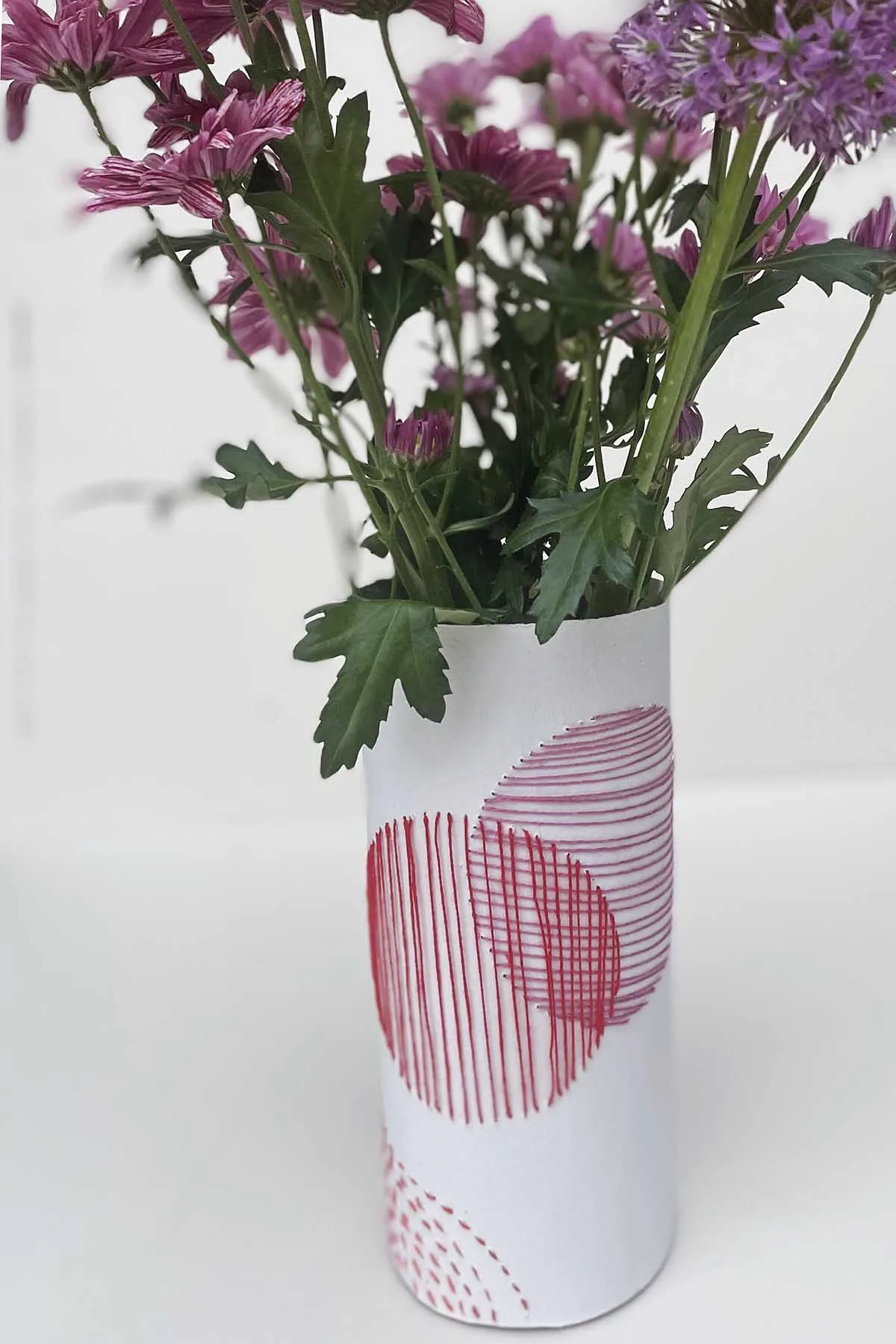Pink embroidered paper vase close up