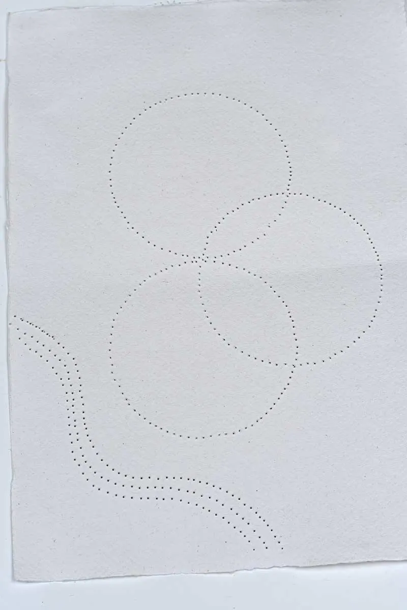 paper punched with holes ready for stitching