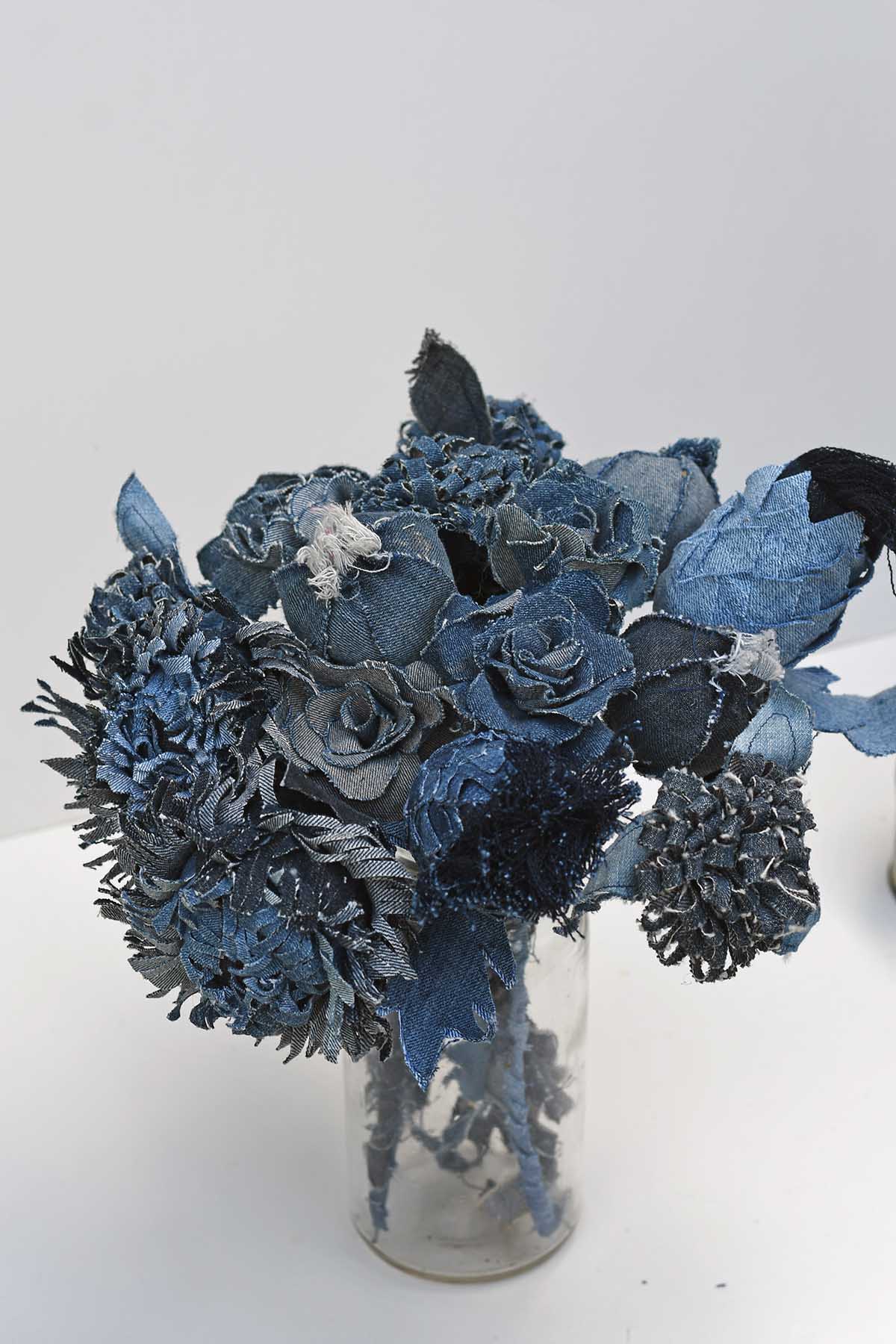 bunch of denim flowers including poppy heads, roses, thistles and Chrysanthemums