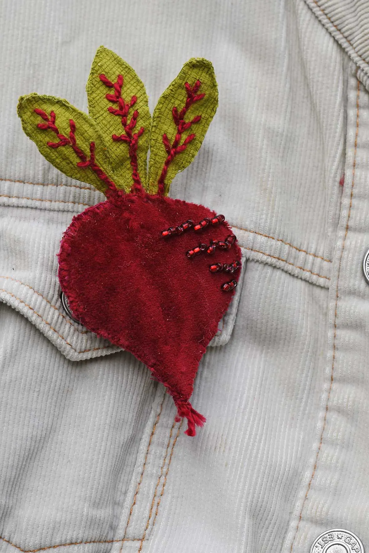 Finished beetroot brooch made from velvet scrap fabric