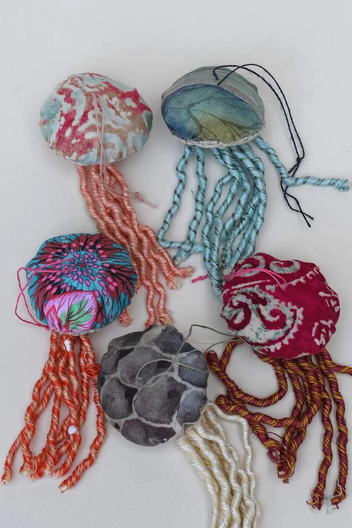 five fabric jellyfish in different colours and patterns.