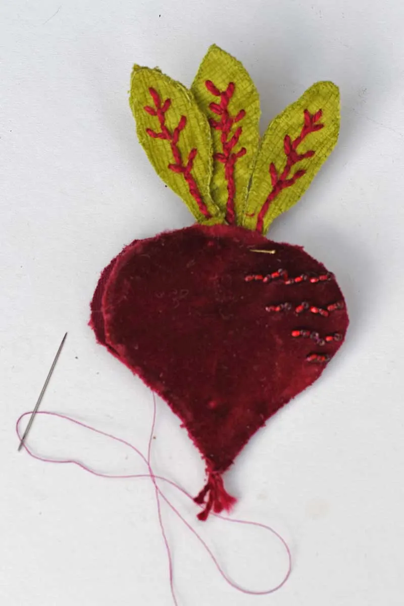 sewing up the beetroot brooch