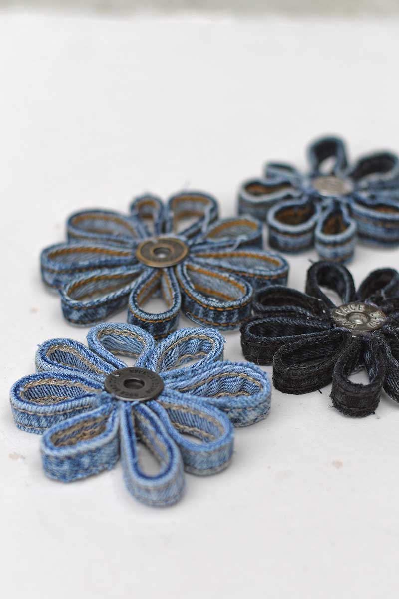 four different coloured denim belt loop ornament medallion daisies