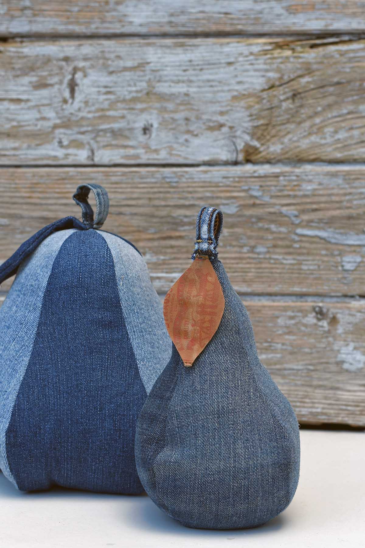 Two denim pear door stops in different shapes