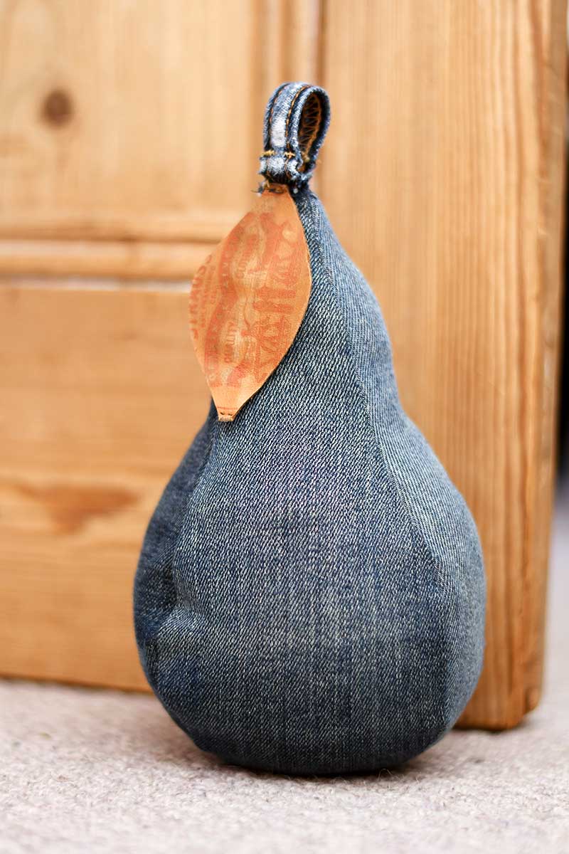 fabric pear door stop made out of denim by the door