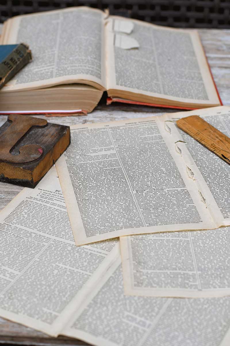 old book pages and books with ruler and wooden type