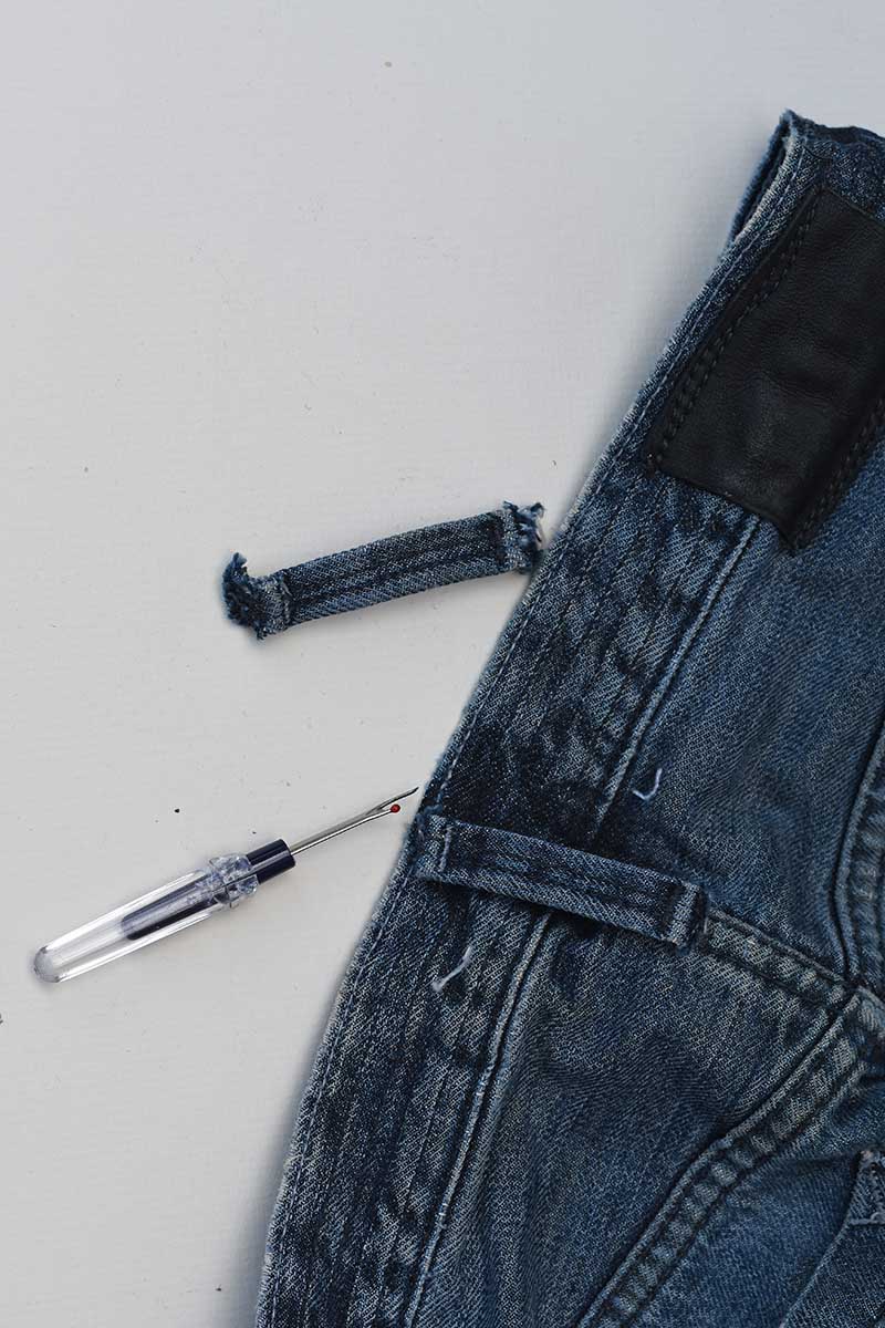 removing jean belt loops with a seam ripper