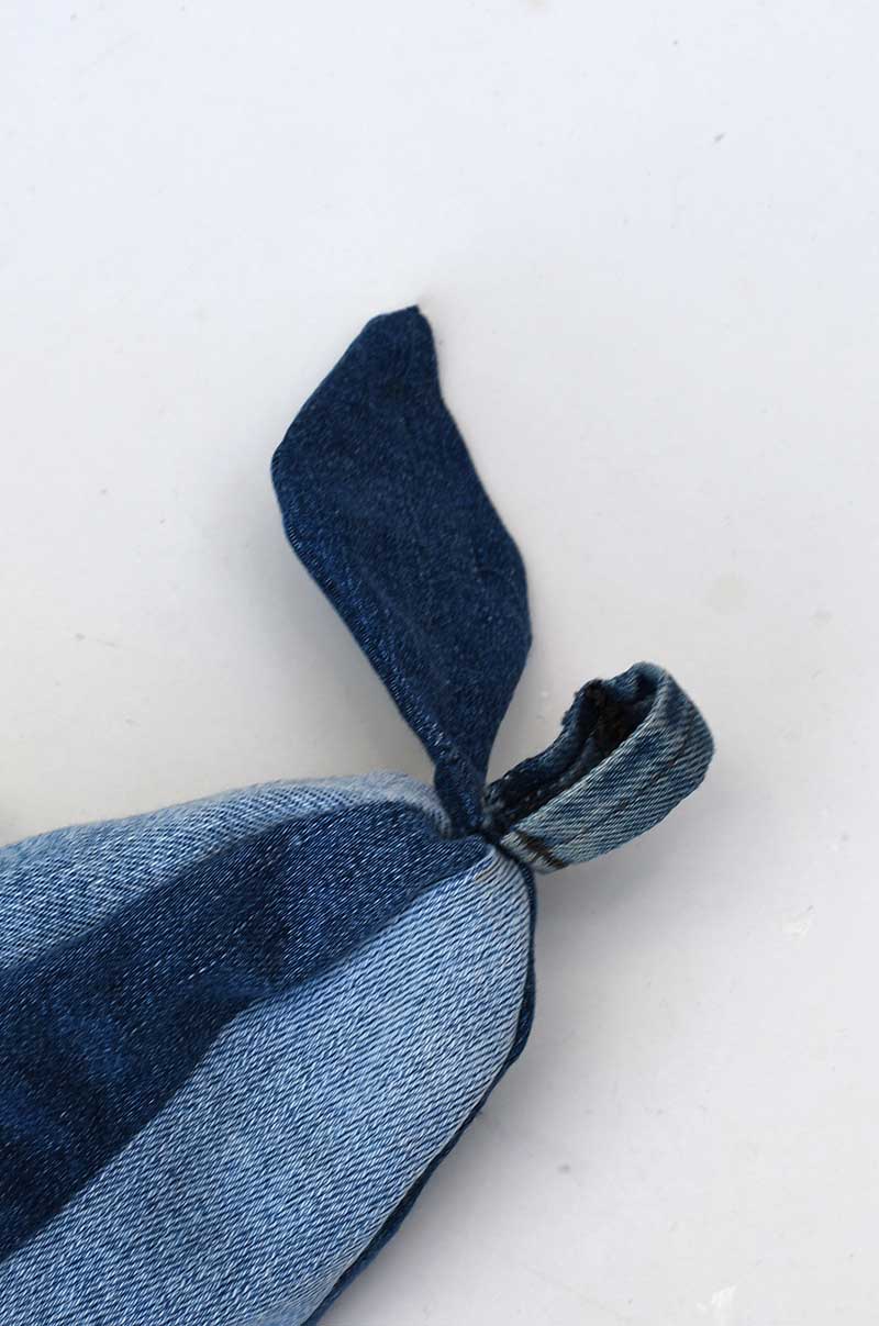 hand sewing the leaf to the top of the fabric pear denim door stip