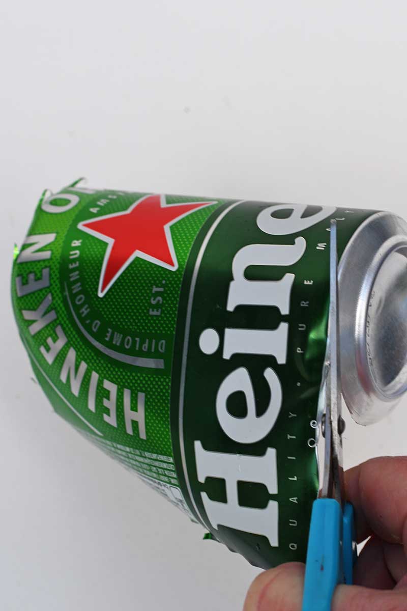 cutting a Heineken Can with scissors