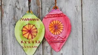 one green and one red embroidered paper bauble ornaments