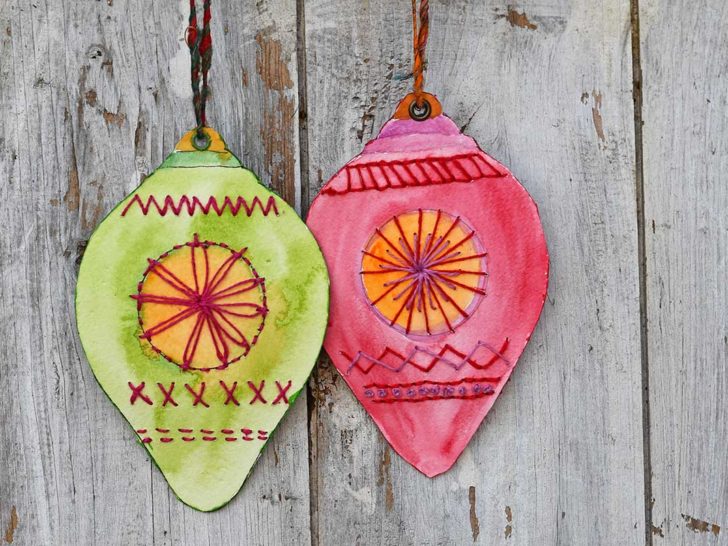 one green and one red embroidered paper bauble ornaments