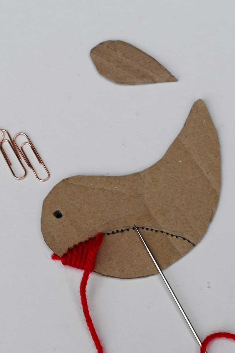 embroidering the robin ornament red breast with wool