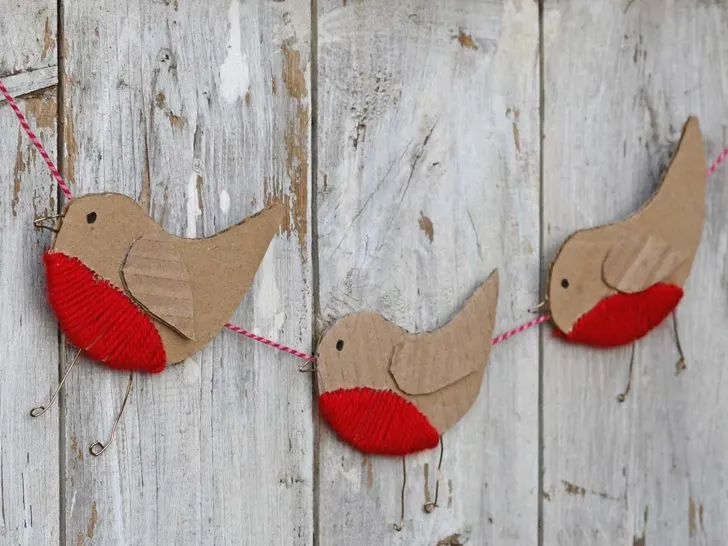 three cardboard robin ornaments in a garland