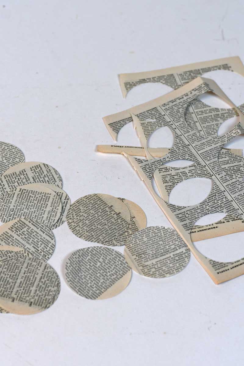 paper discs punched out of old book pages