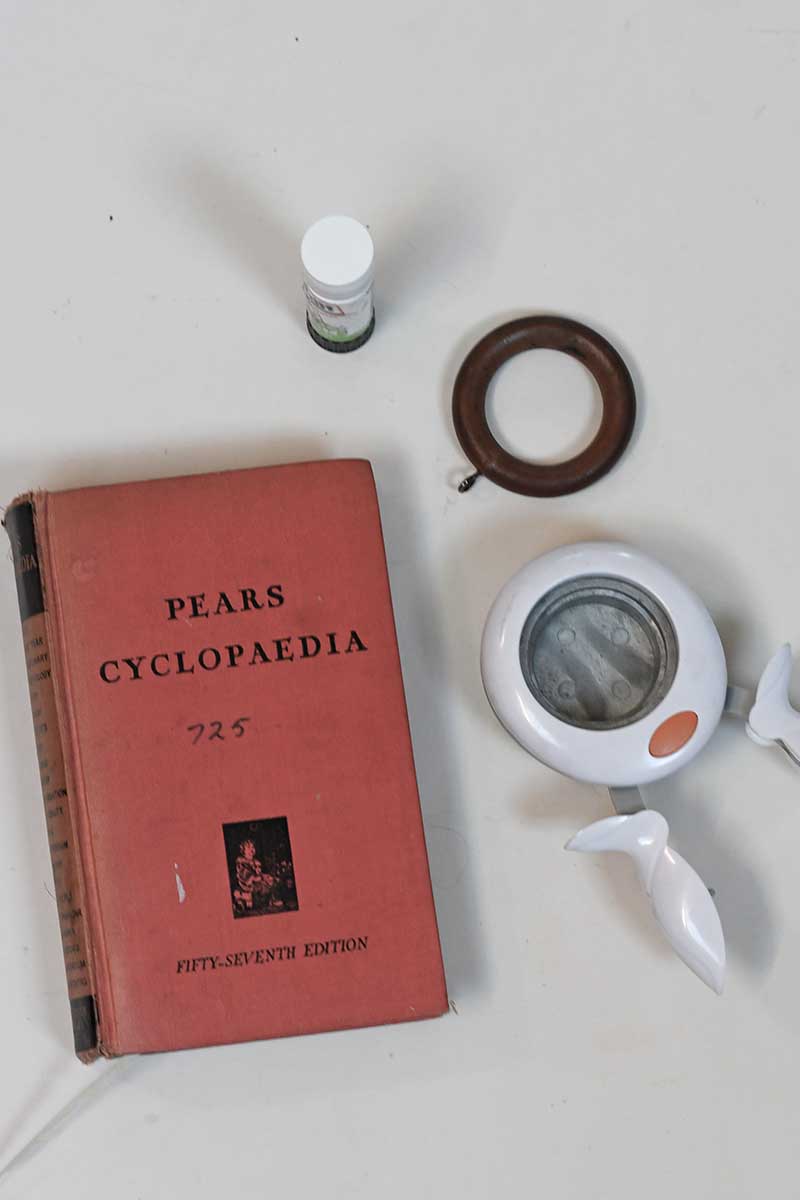 old pears cyclopedia and curtain ring glue stick and round paper punch