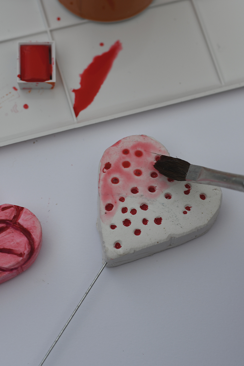 painting air dry clay with red-pink watercolour paint