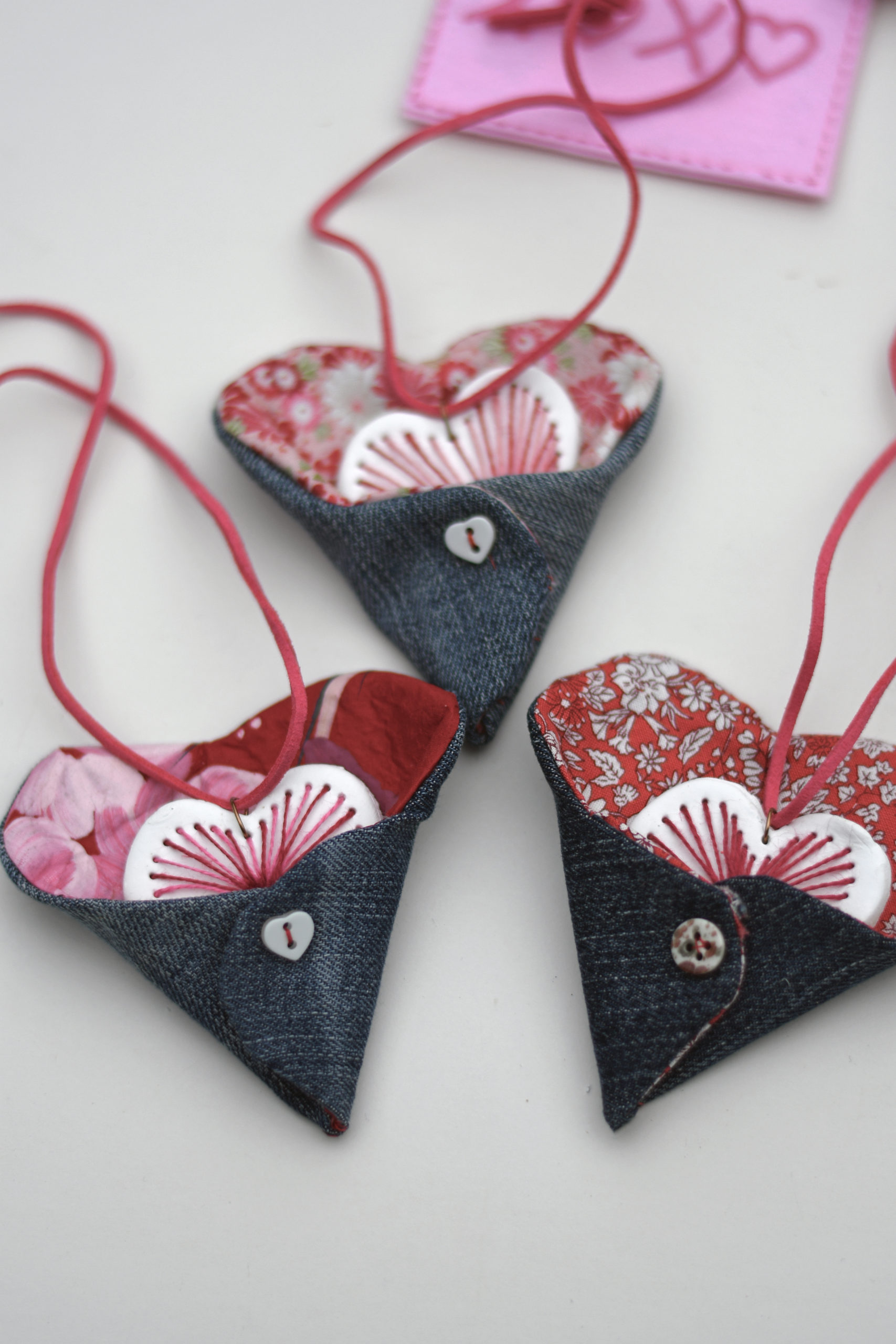 3 denim fabric heart pockets with embroidered clay hearts