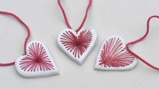 three red and pink embroidered air dry clay heart pendant necklaces