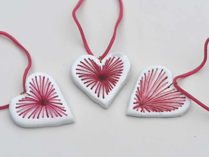 three red and pink embroidered air dry clay heart pendant necklaces